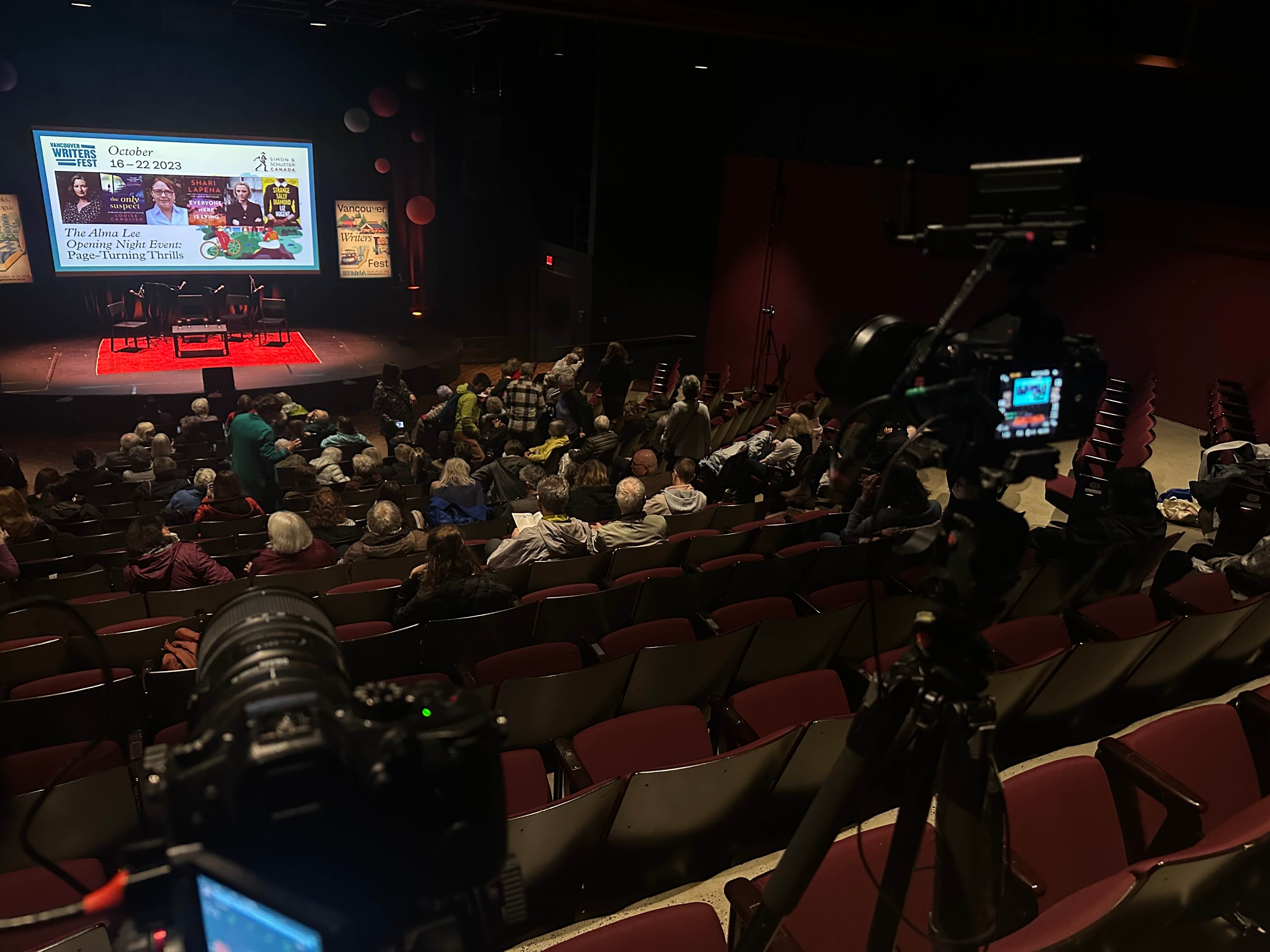 Spacious auditorium with a big screen and camera. AV Mobile event with live streaming service.